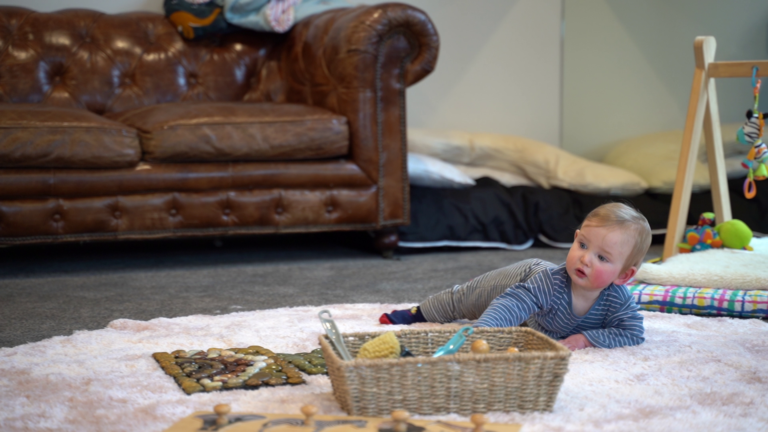 a baby crawling in a fluffy carpet